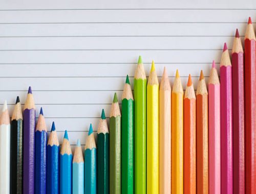 A bar graph made of colored pencils shows fluctuations but a general uptrend A bar graph made of colored pencils shows fluctuations but a general uptrend